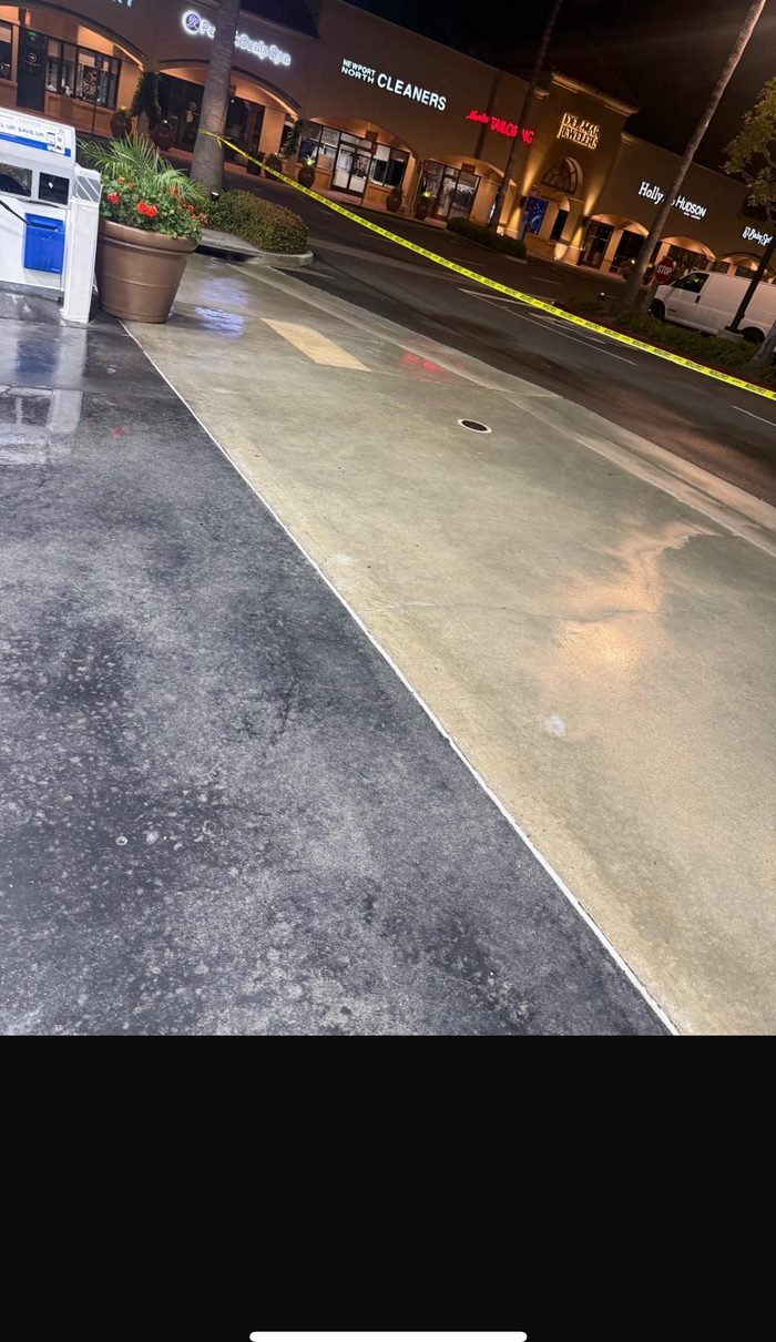 Commercial concrete cleaning or pressure-washing equipment in use
