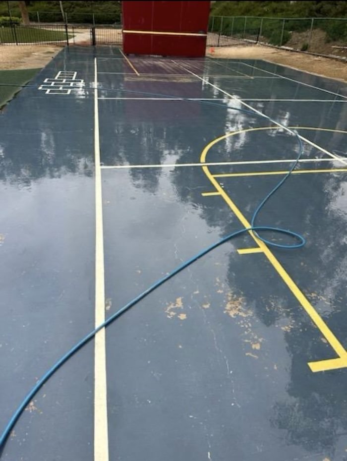 Court surface and rebound wall service at a campus recreation area