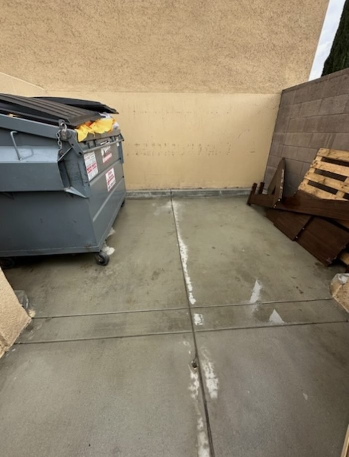 Enclosure slab washed clean, container rolled back into place