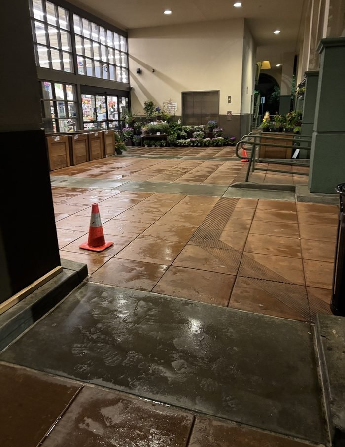 Grocery entry tile and walk-off area cleaned and drying before opening
