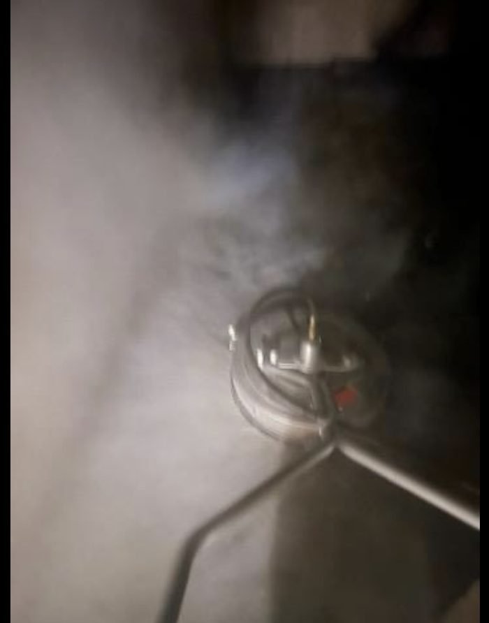 Steam rising off the hot-water surface cleaner during a night service-area clean