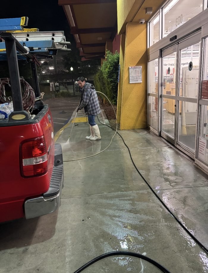 Entrance concrete washed at a national pharmacy storefront during overnight service