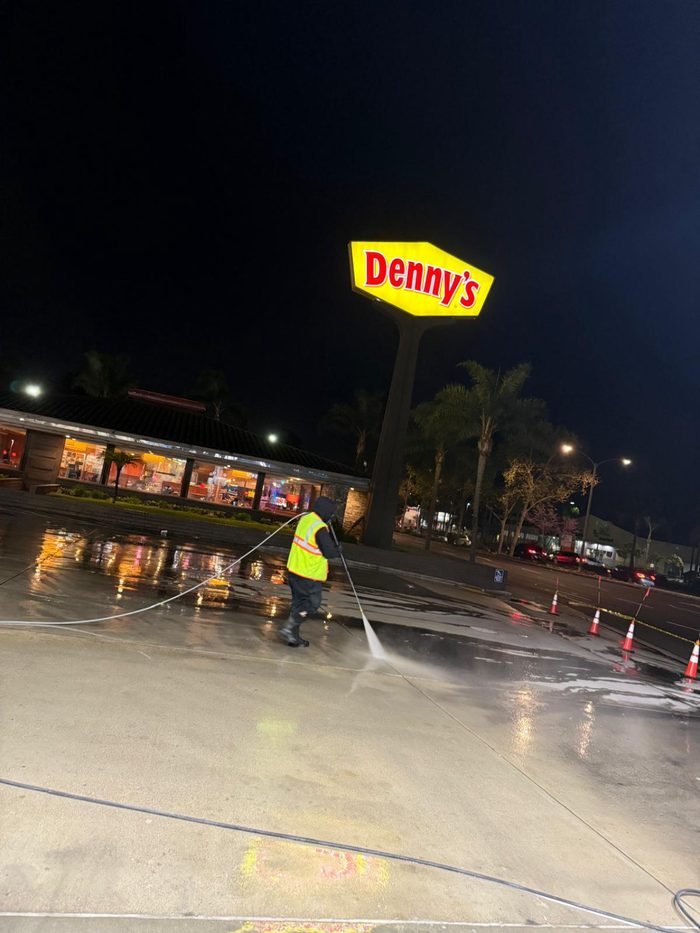 Restaurant parking area being pressure washed at night