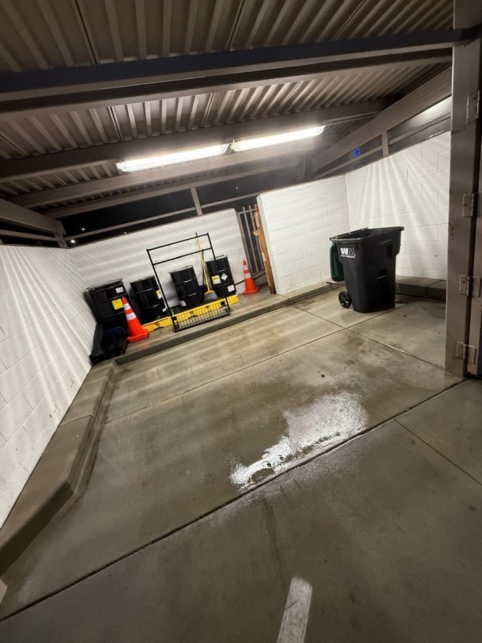 Clean commercial service enclosure with waste containers